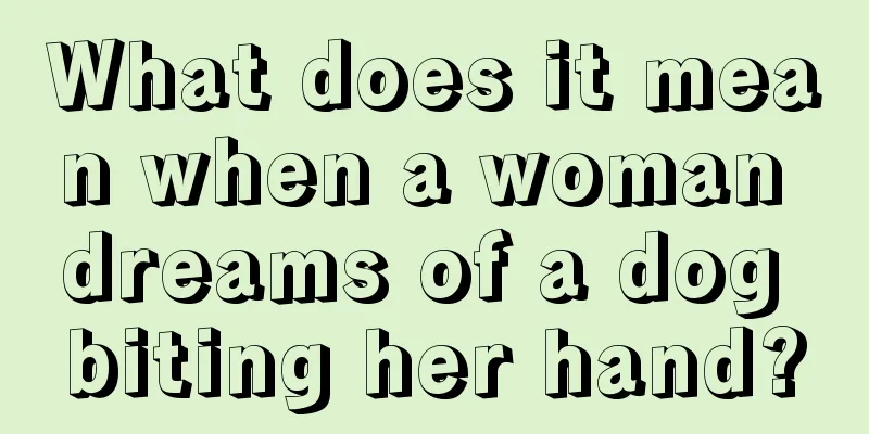 What does it mean when a woman dreams of a dog biting her hand?