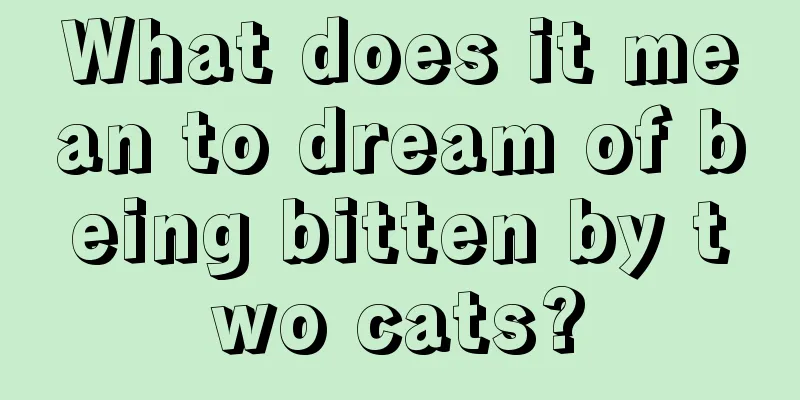 What does it mean to dream of being bitten by two cats?