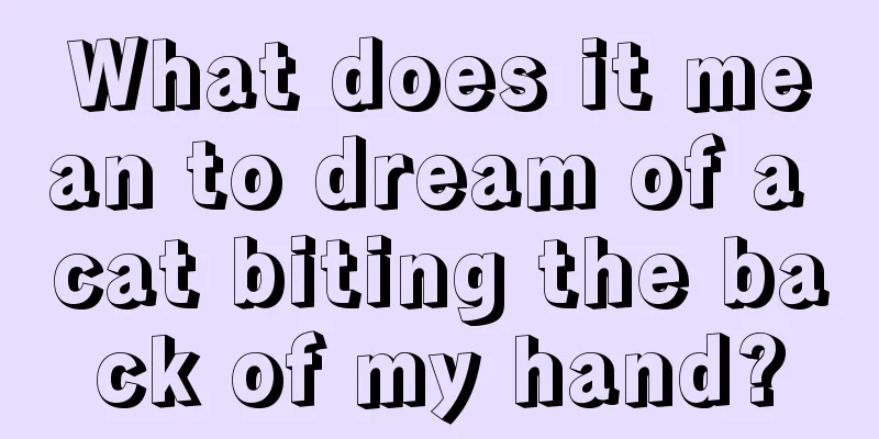 What does it mean to dream of a cat biting the back of my hand?