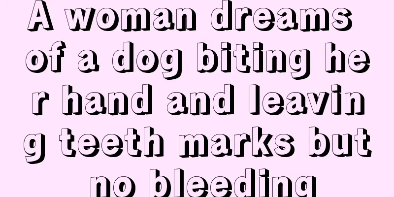 A woman dreams of a dog biting her hand and leaving teeth marks but no bleeding