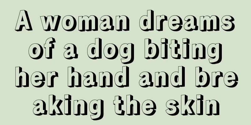 A woman dreams of a dog biting her hand and breaking the skin