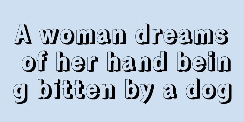 A woman dreams of her hand being bitten by a dog