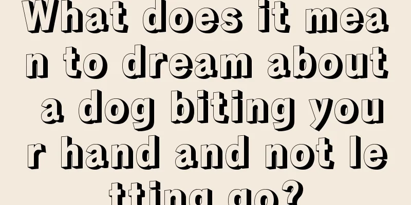 What does it mean to dream about a dog biting your hand and not letting go?