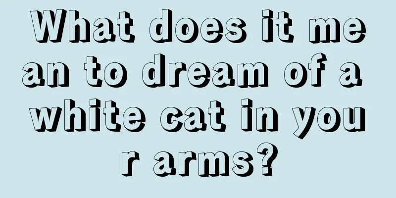 What does it mean to dream of a white cat in your arms?