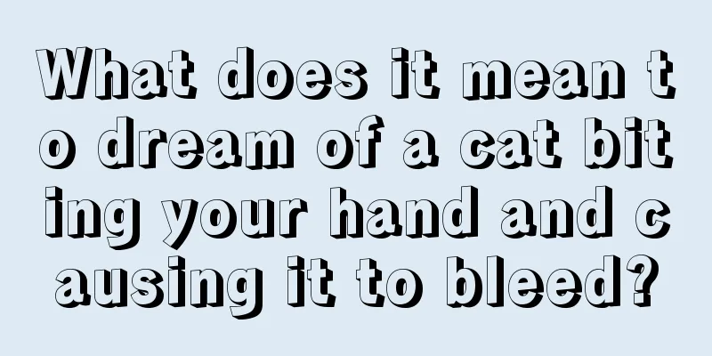 What does it mean to dream of a cat biting your hand and causing it to bleed?