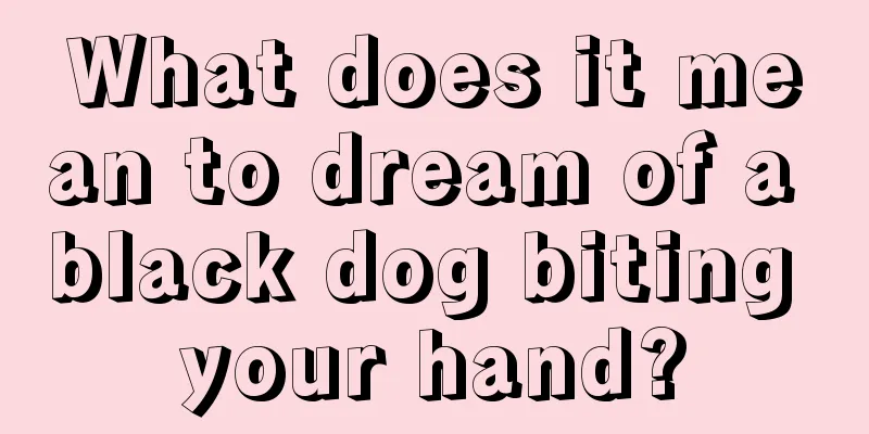 What does it mean to dream of a black dog biting your hand?