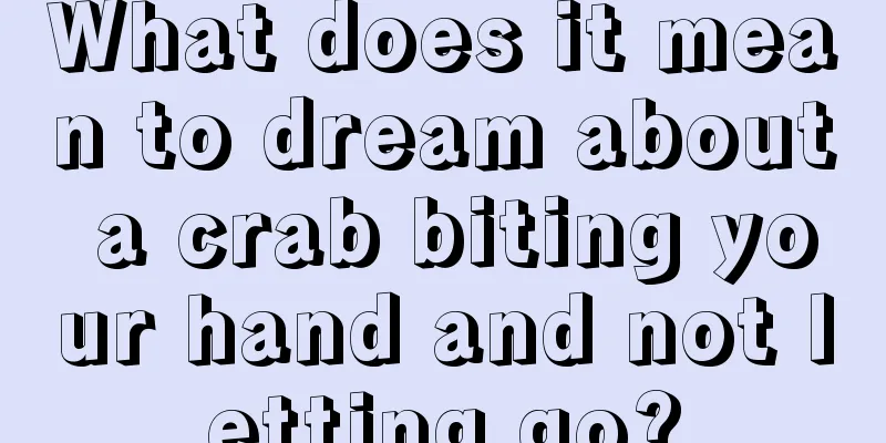 What does it mean to dream about a crab biting your hand and not letting go?